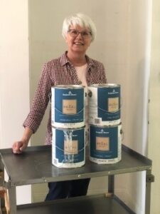 Vicky Duke with donated paint for the Welcome Project room
